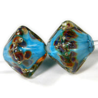 https://covergirlbeads.com/collections/handmade-lampwork-diamond-glass-beads/products/handmade-lampwork-glass-diamond-beads-dk-sky-blue-raku-silver-encased