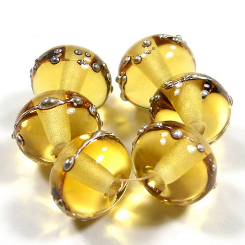 Pale amber yellow handmade lampwork beads wrapped in fine silver