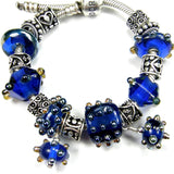 Example group showing cobalt large hole lampwork bead and charm along with other similar colors and styles