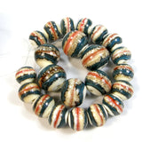 Example showing different variances of of coral persimmon orange band in the middle of southwest lampwork bead with ivory and blue. These examples have small holes but the listing is for large holes